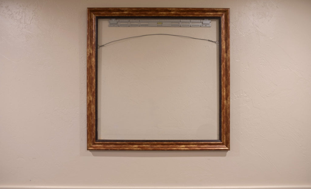 Ornate gold frame hung level on a wall