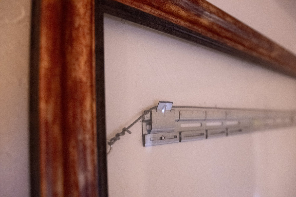 Close-up of picture wire hooked onto a SecurArt mount bracket